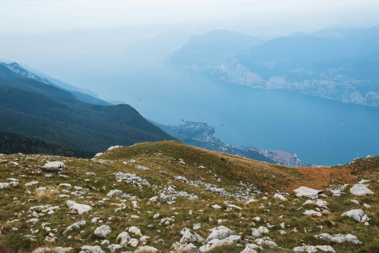 there is a sheep that is standing on the edge of a mountain