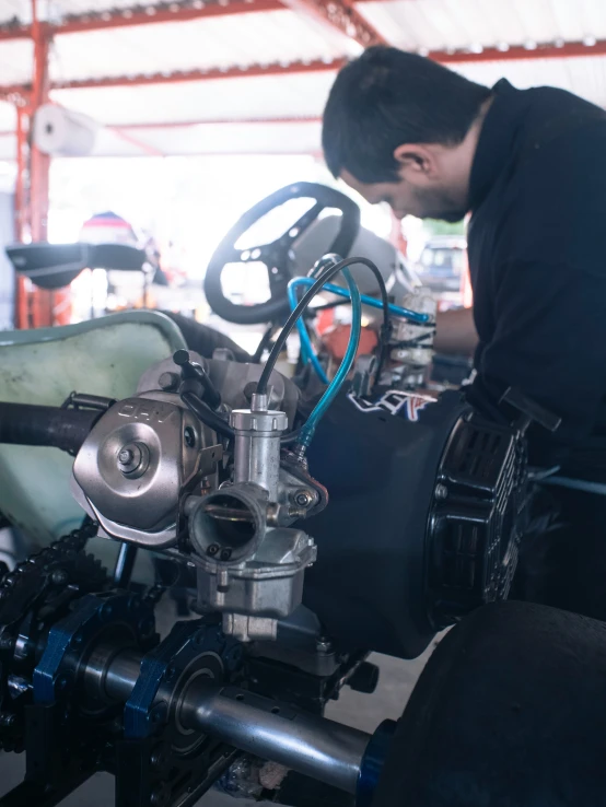 man operating a machine with one hand while another stands on his chest