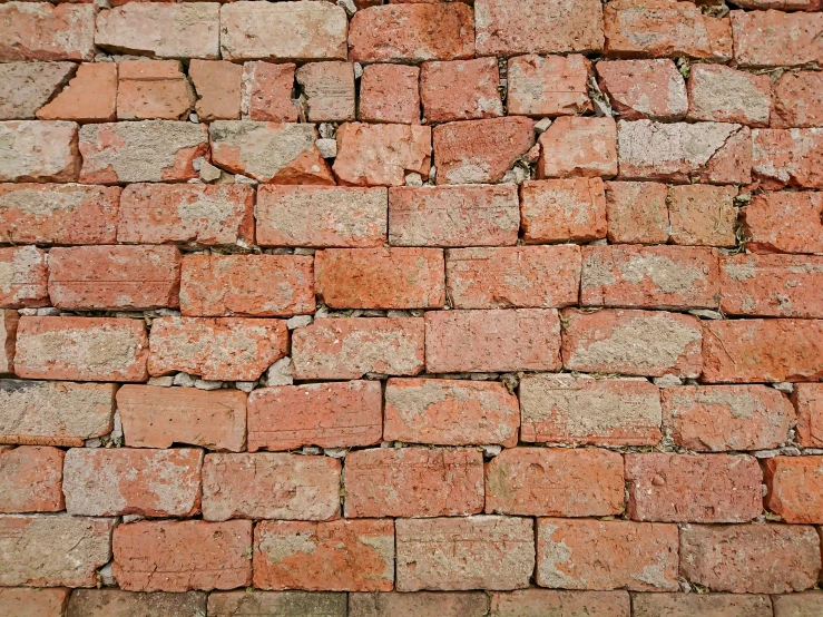 a red brick wall with small white dots and an orange one