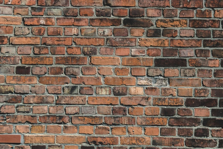 a very large brown brick wall with no mortars