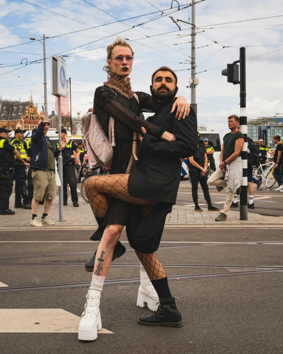 a couple in costume standing on the sidewalk