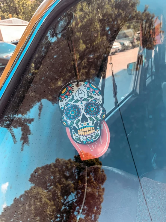 a skull is displayed on the back window of a car