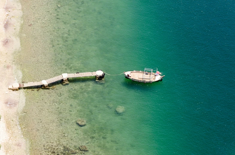 a boat out on the ocean near a pier