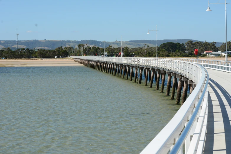 the pier has two boards, leading out into the water