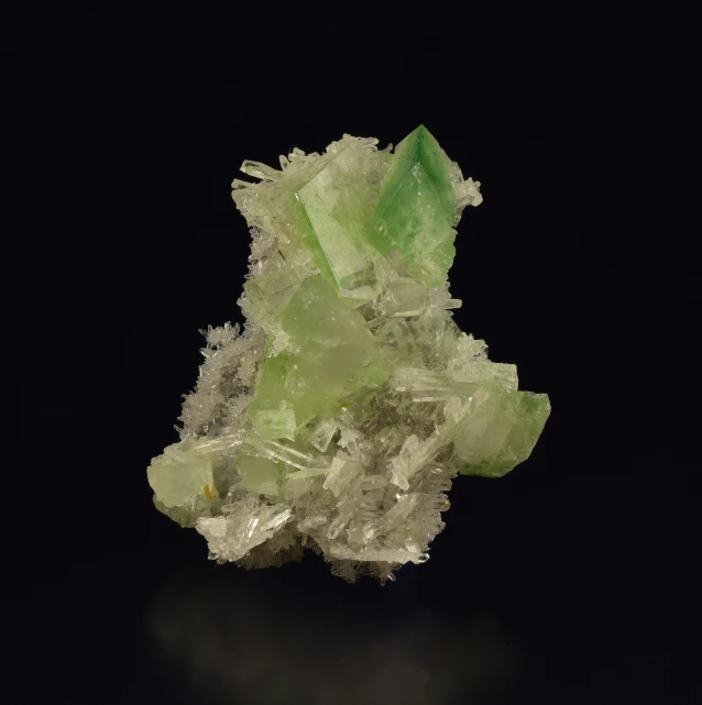 a cluster of light green crystals on black background