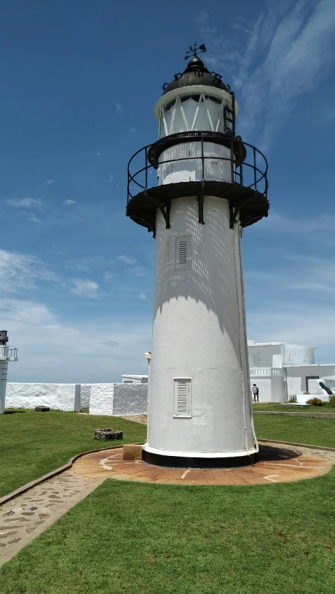 the light house sits near a stone path