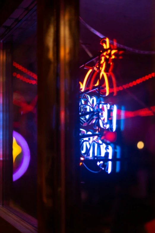 a neon sign in the window of a bike shop
