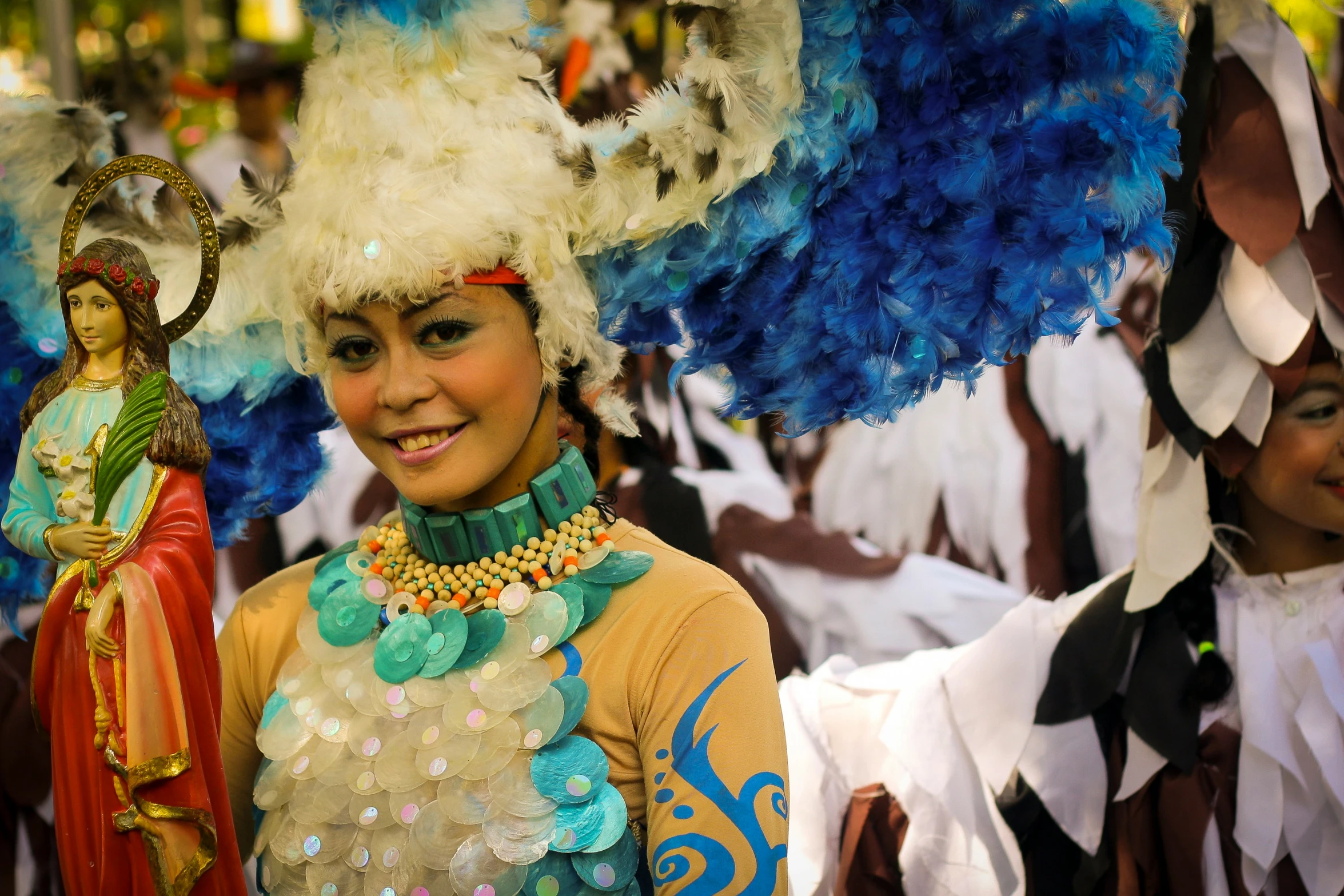 a girl wearing brightly colored costume next to colorful performers