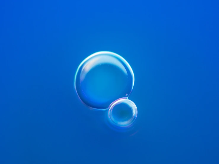 a drop of water that is on top of blue paper