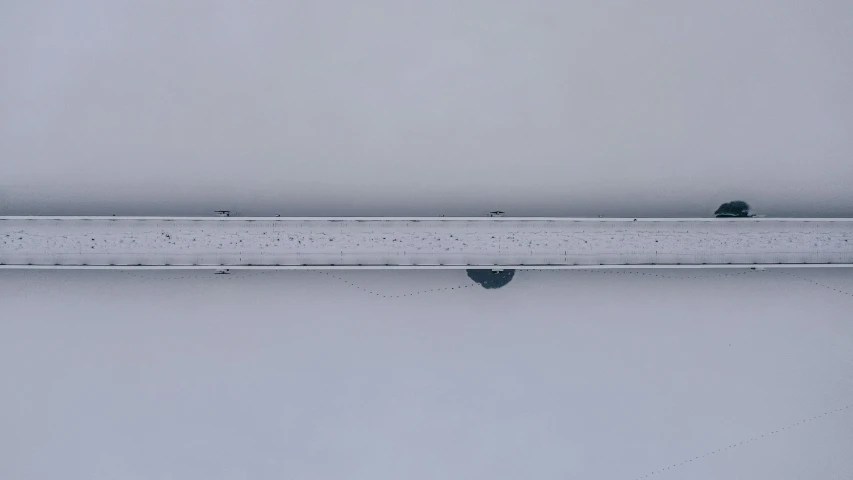 a single car is shown on a snowy day