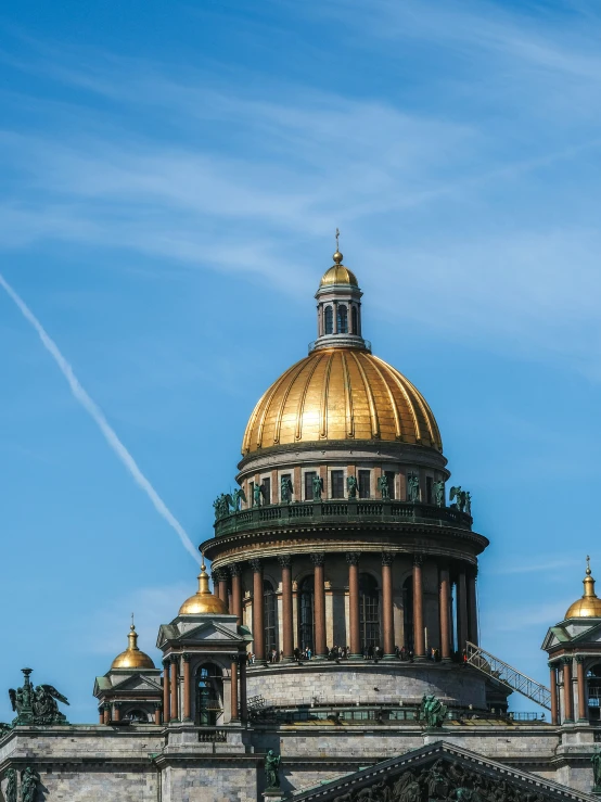 a building with many dome on top under blue skies