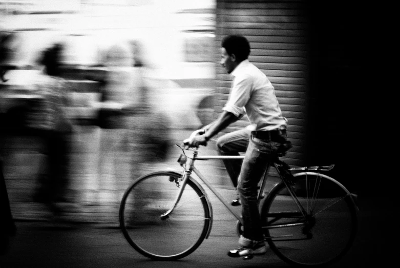 a black and white po of a man on a bicycle