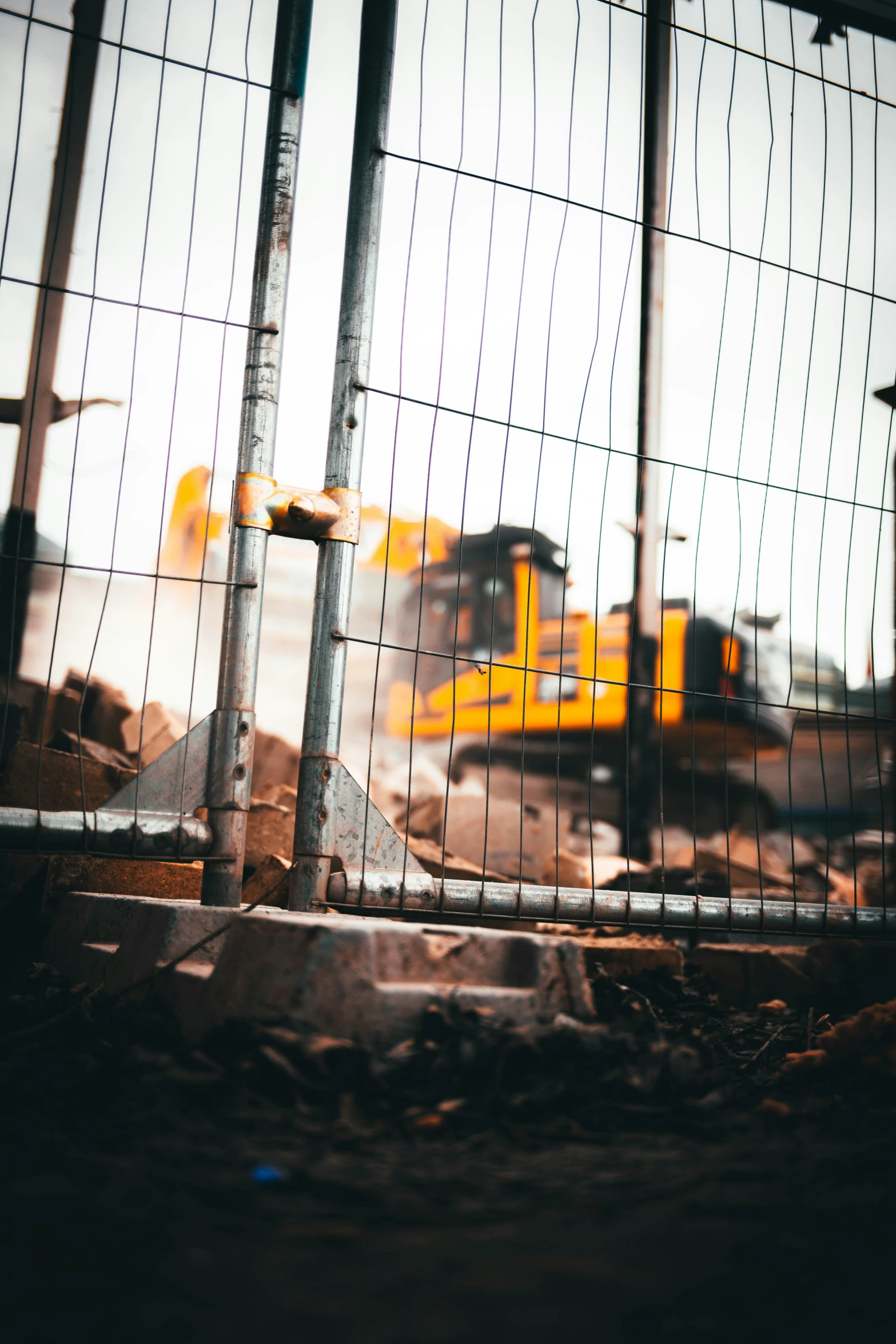 a truck is behind a wire fence that looks like it was cut off