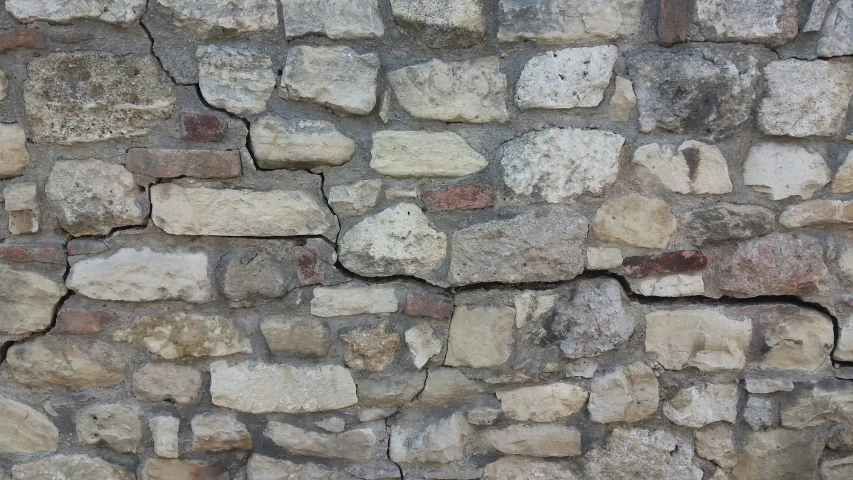 the wall has different sized stones on it