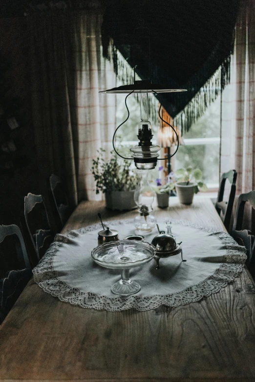 a dining room with a round table and several plants