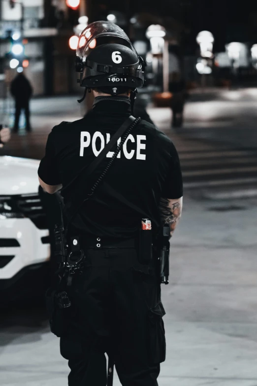 a person in a black shirt stands on the sidewalk