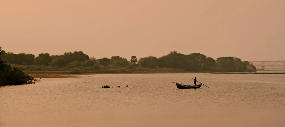 two canoes are seen in a still body of water