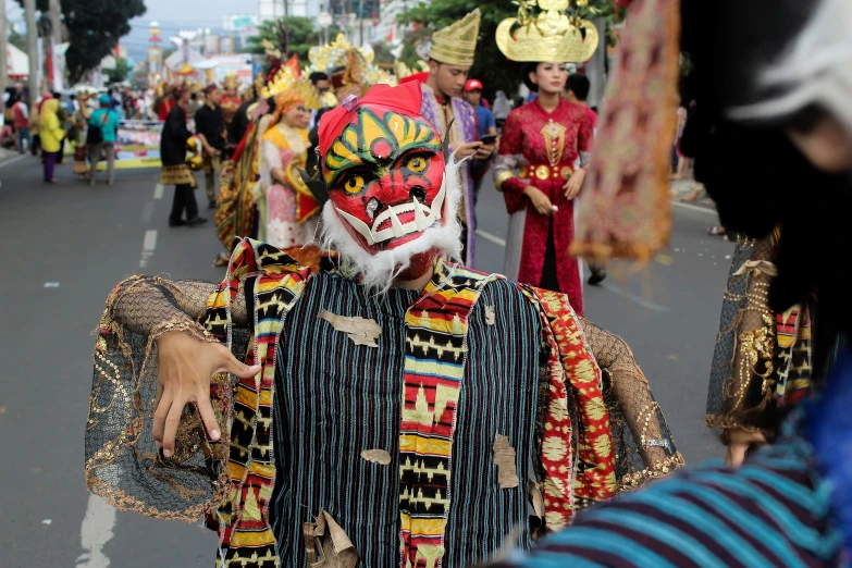 a person with face paint and many other people are standing