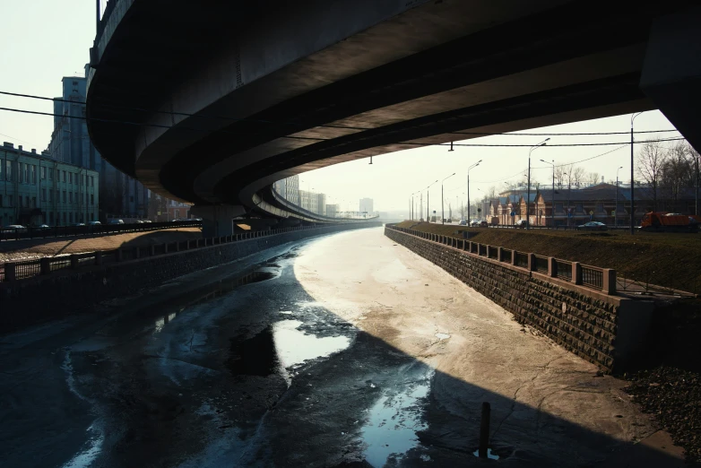 the highway under a bridge in an area covered in ice