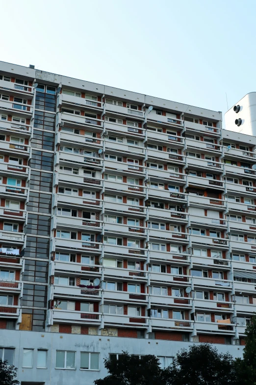 the building has multiple balconies and broken windows