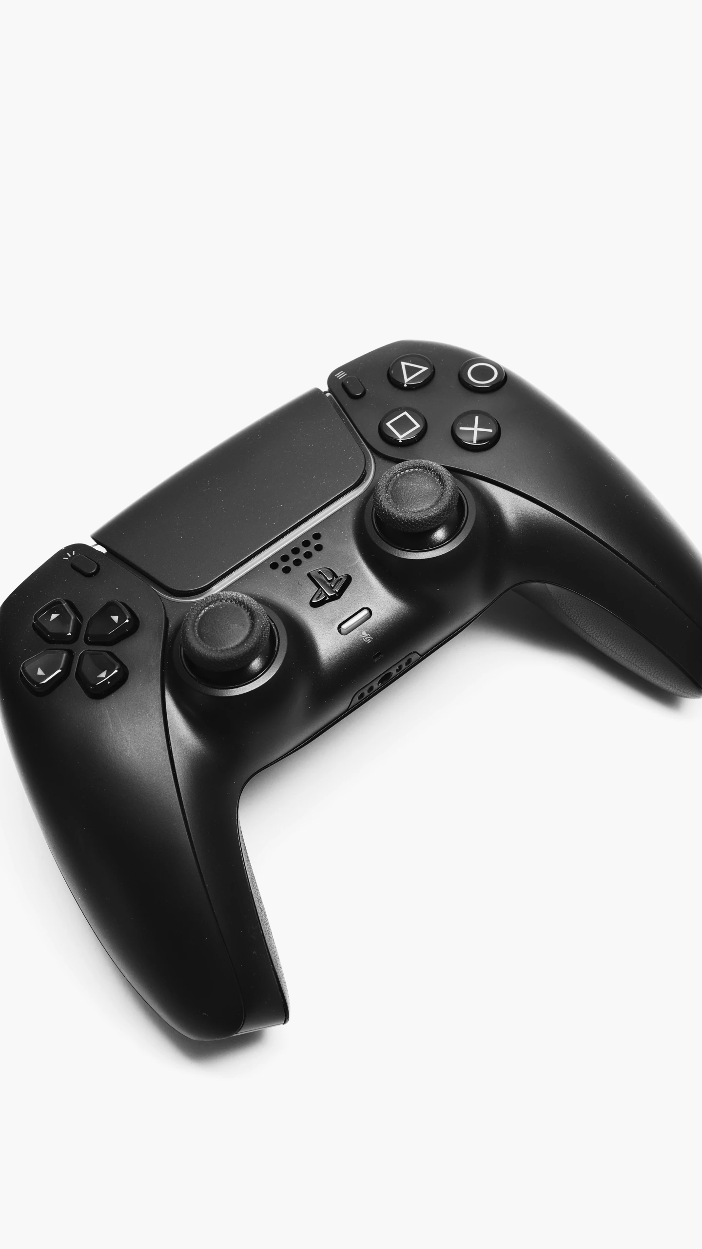 a black video game controller on a white background