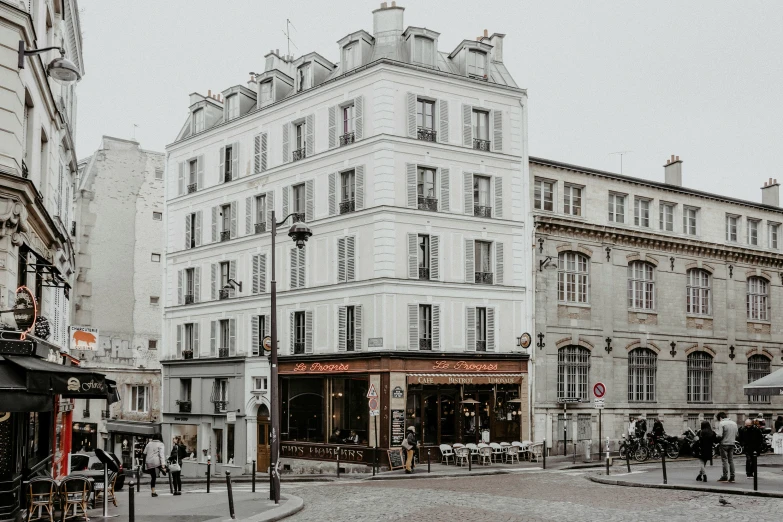 a tall building is shown on a city street