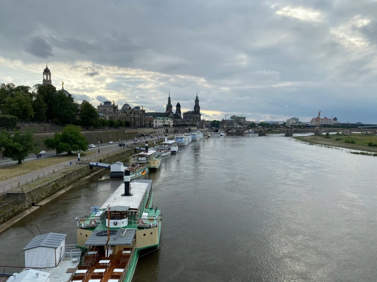 this is a picture of a long barge docked in the river