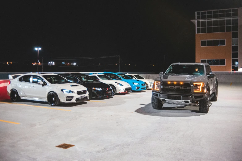 several different colored cars parked in a parking lot