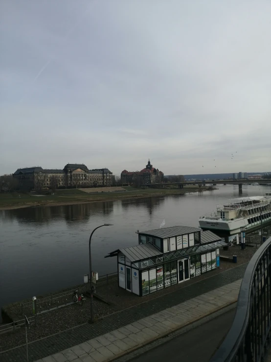 a waterway with two boats and a bridge in the background