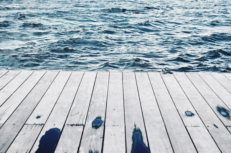 a pier near the ocean with one person walking across