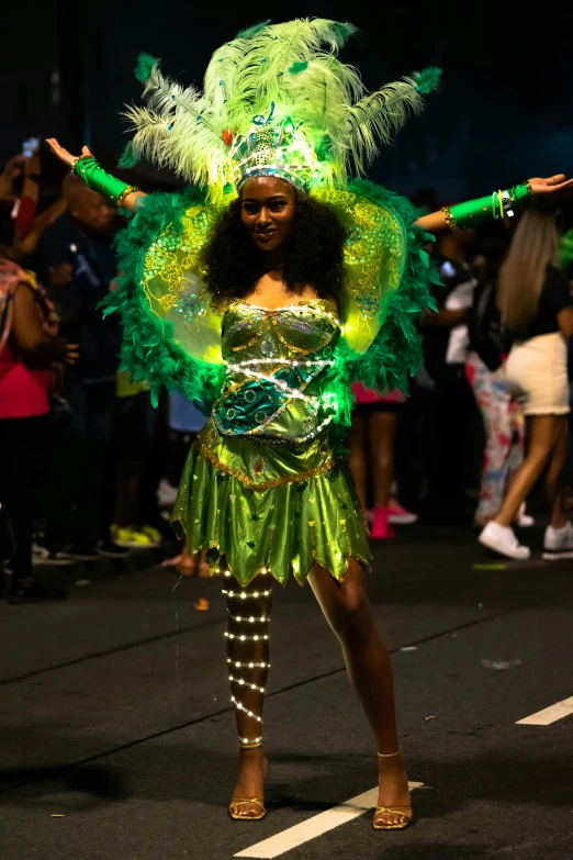 a woman in a green costume holding her hands out