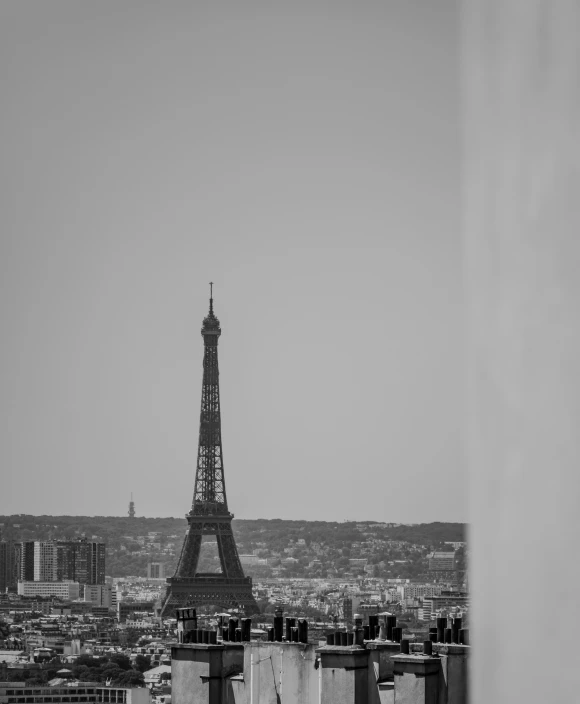 the eiffel tower stands tall in the distance with other buildings around