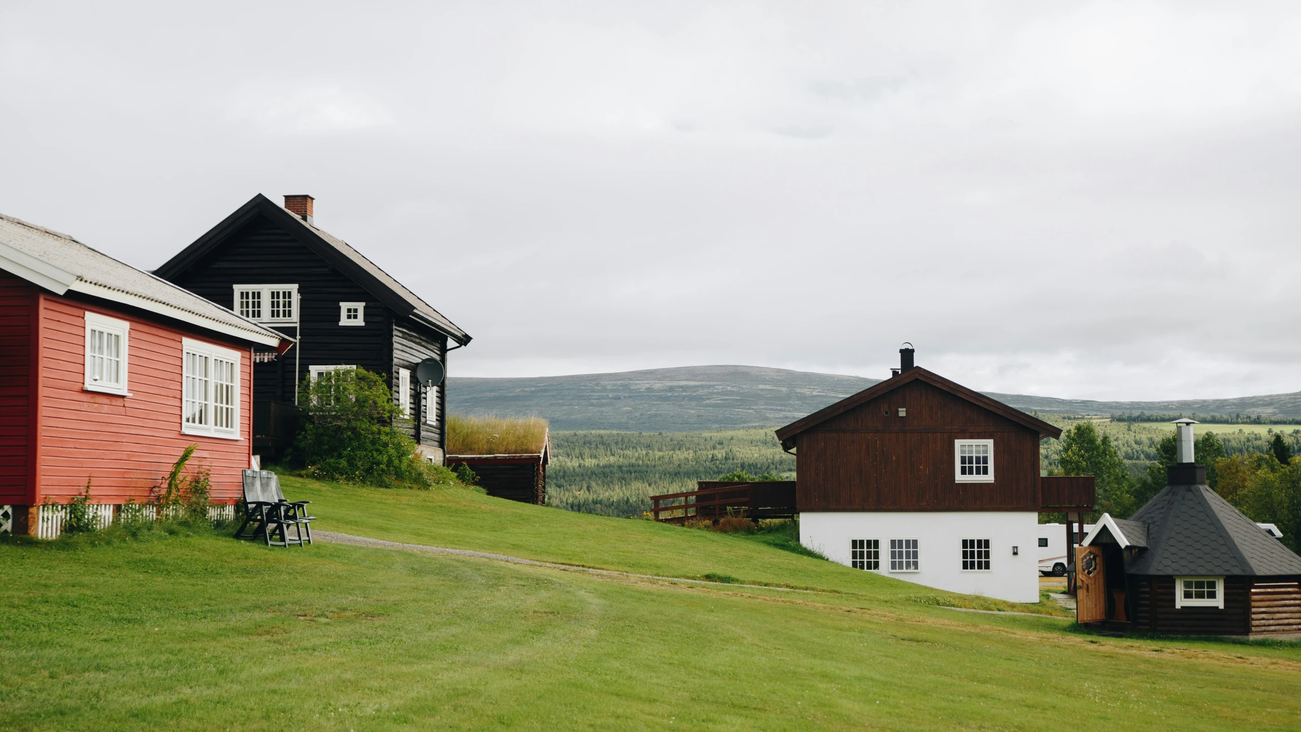 a couple of buildings sit on a hill