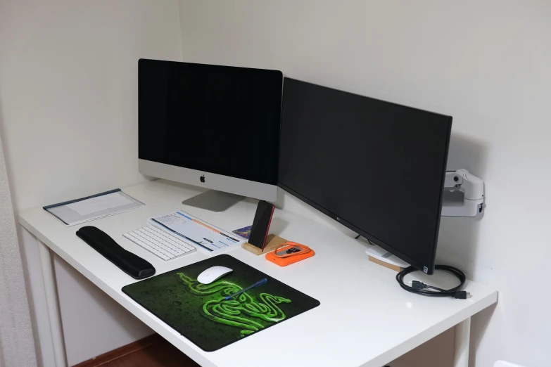 a desk topped with a computer monitor and keyboard