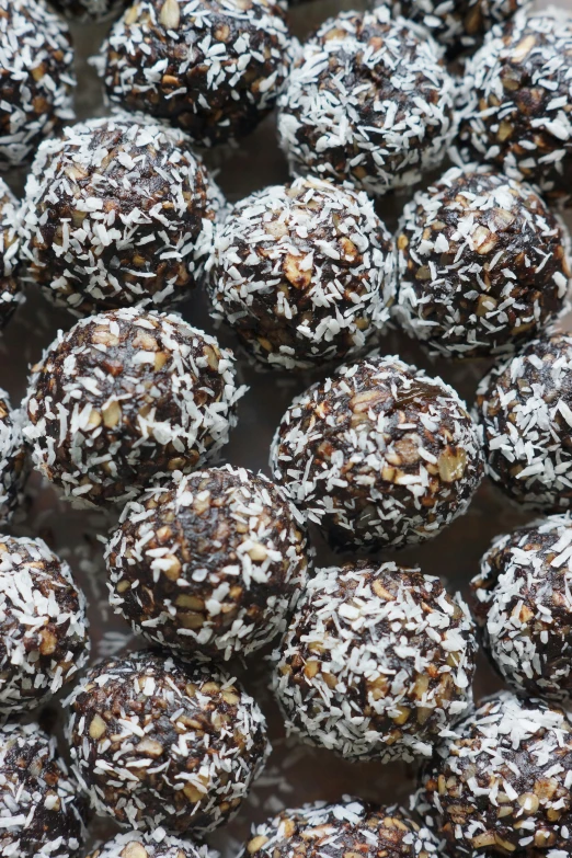 chocolate coated dessert items with coconut in middle