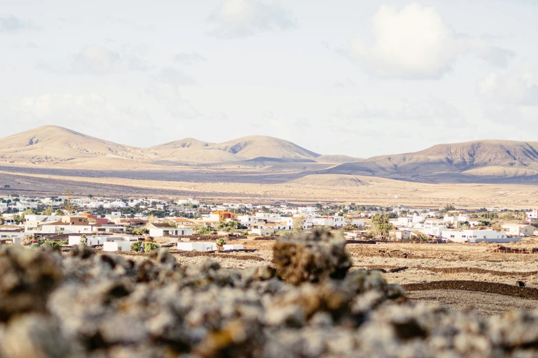 there is a small village and some hills in the background