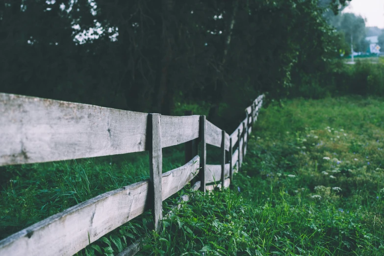 a white fence on the side of the road