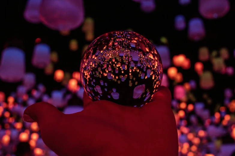 this is an image of a person holding a lighted sphere