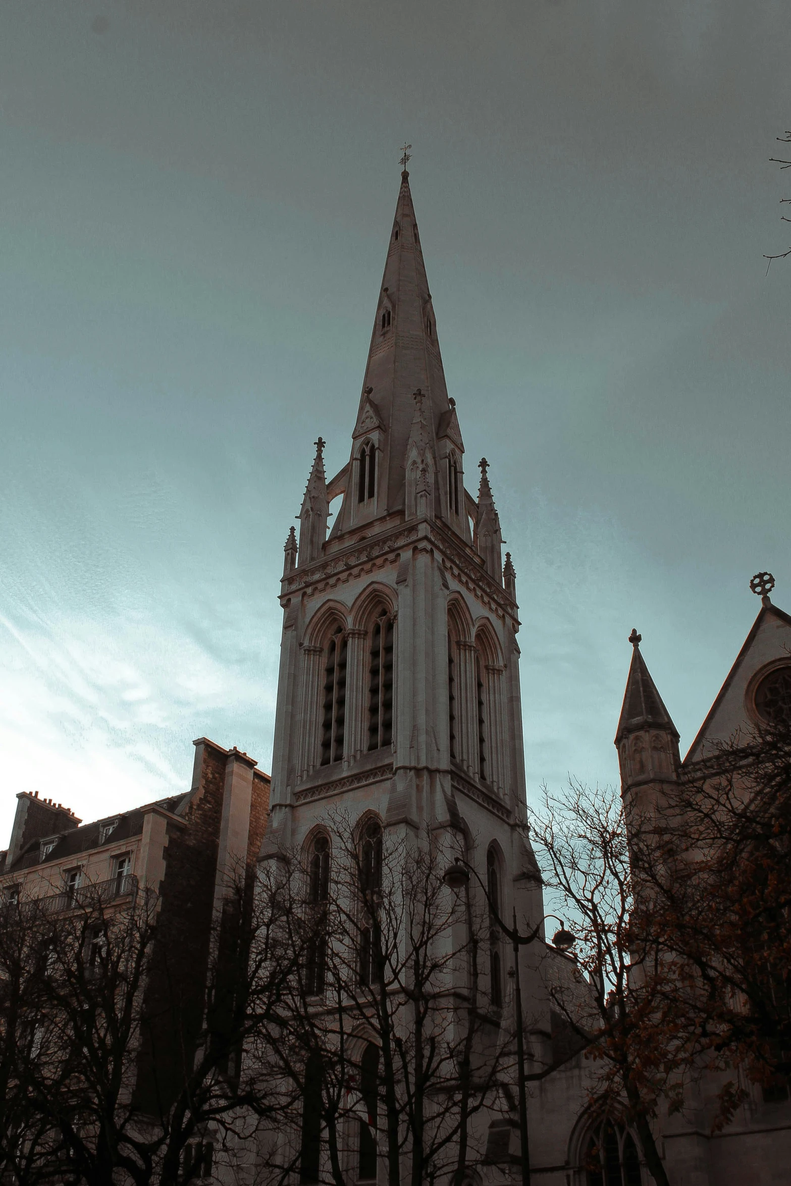 the large spire on the building is made of stone