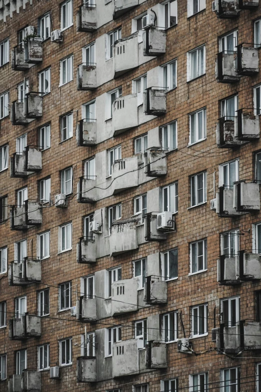 an old building with lots of windows and bars attached to the facade