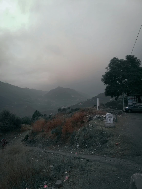 the foggy sky has settled over the hills in the distance