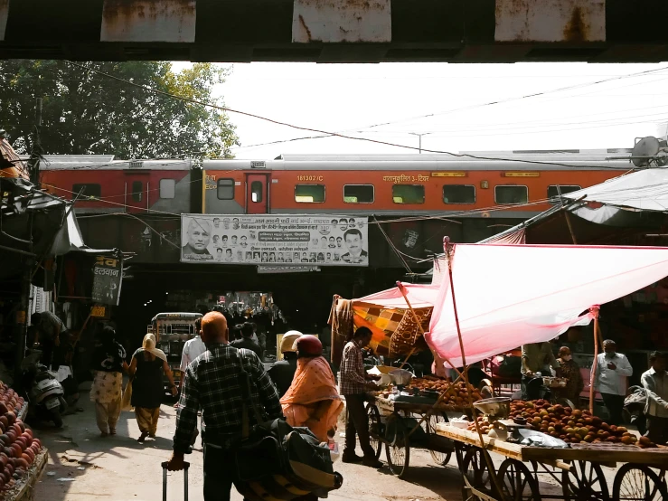 many people in the city market near trains