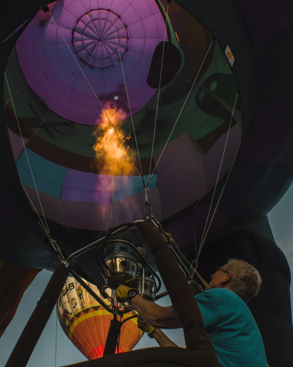 a large colorful  air balloon is being inflated