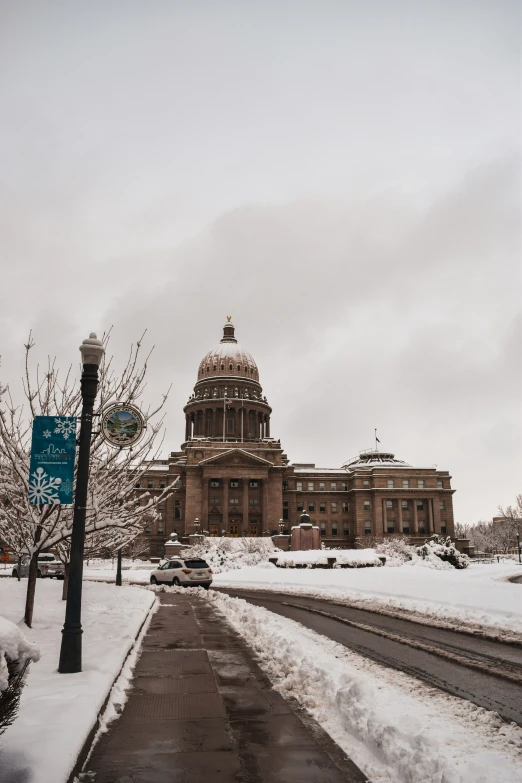 a large building on the side of a snowy road