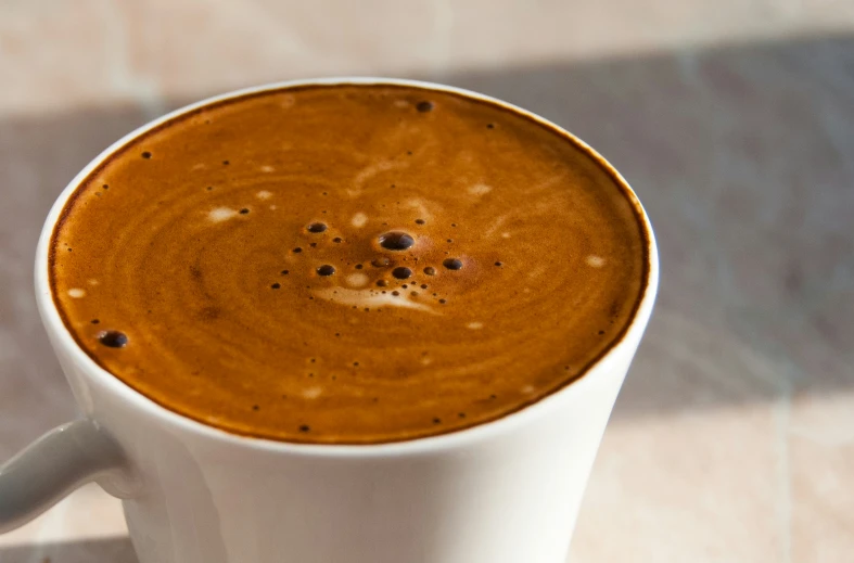 a large cup of coffee is shown in a white cup