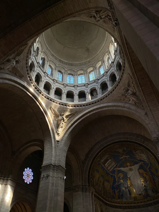 a large cathedral with many pillars and beautiful paintings on it