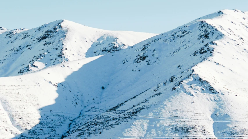 the mountains are covered in white snow