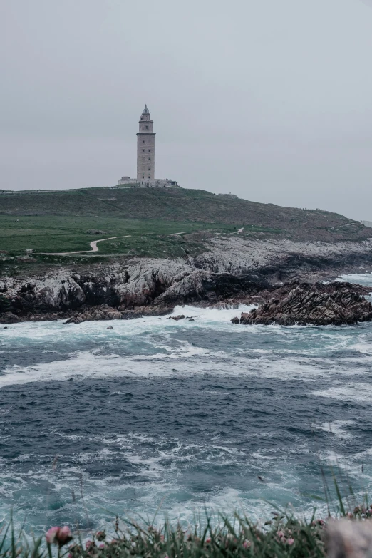 a lighthouse that is on a small hill