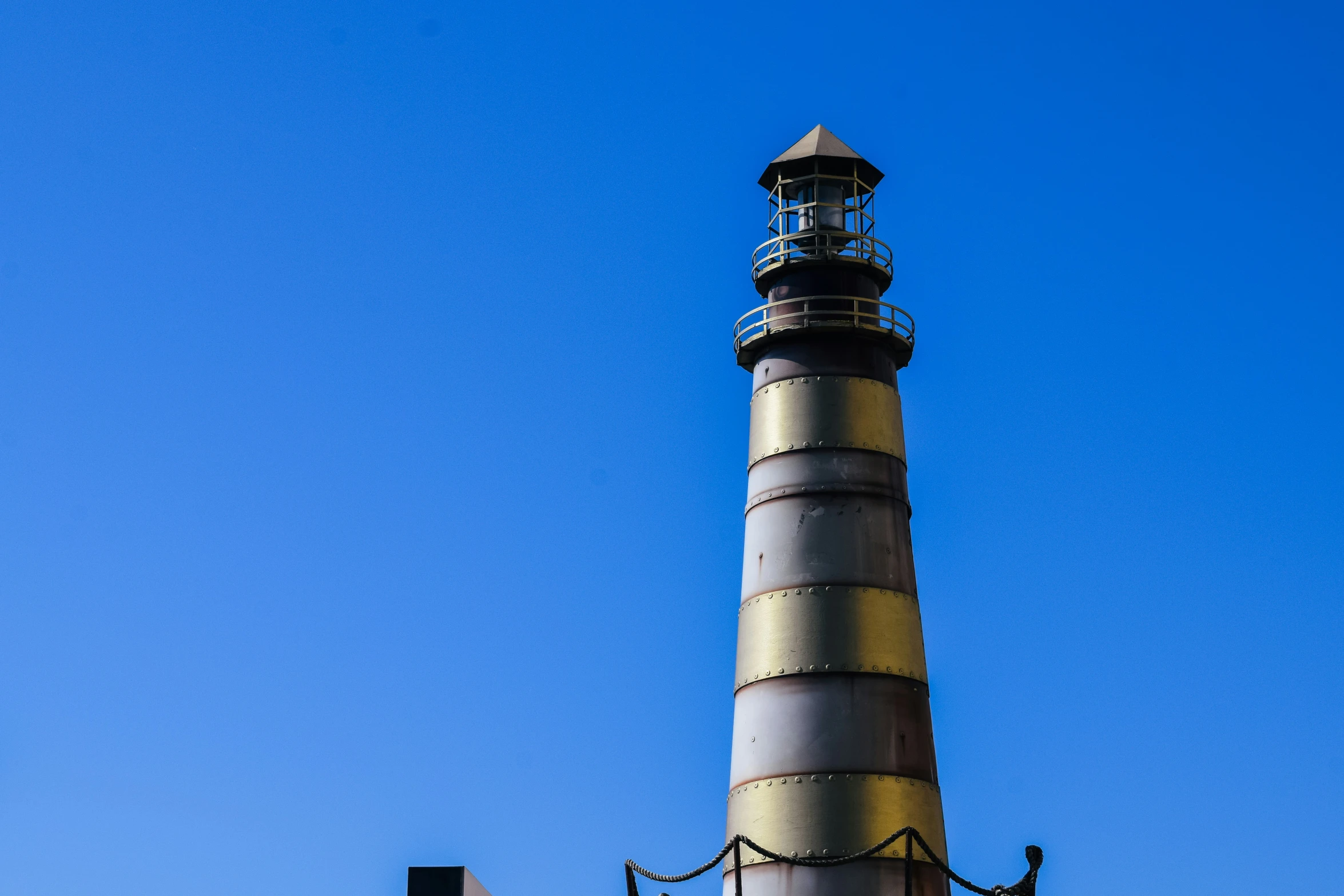 the lighthouse sits in front of a blue sky