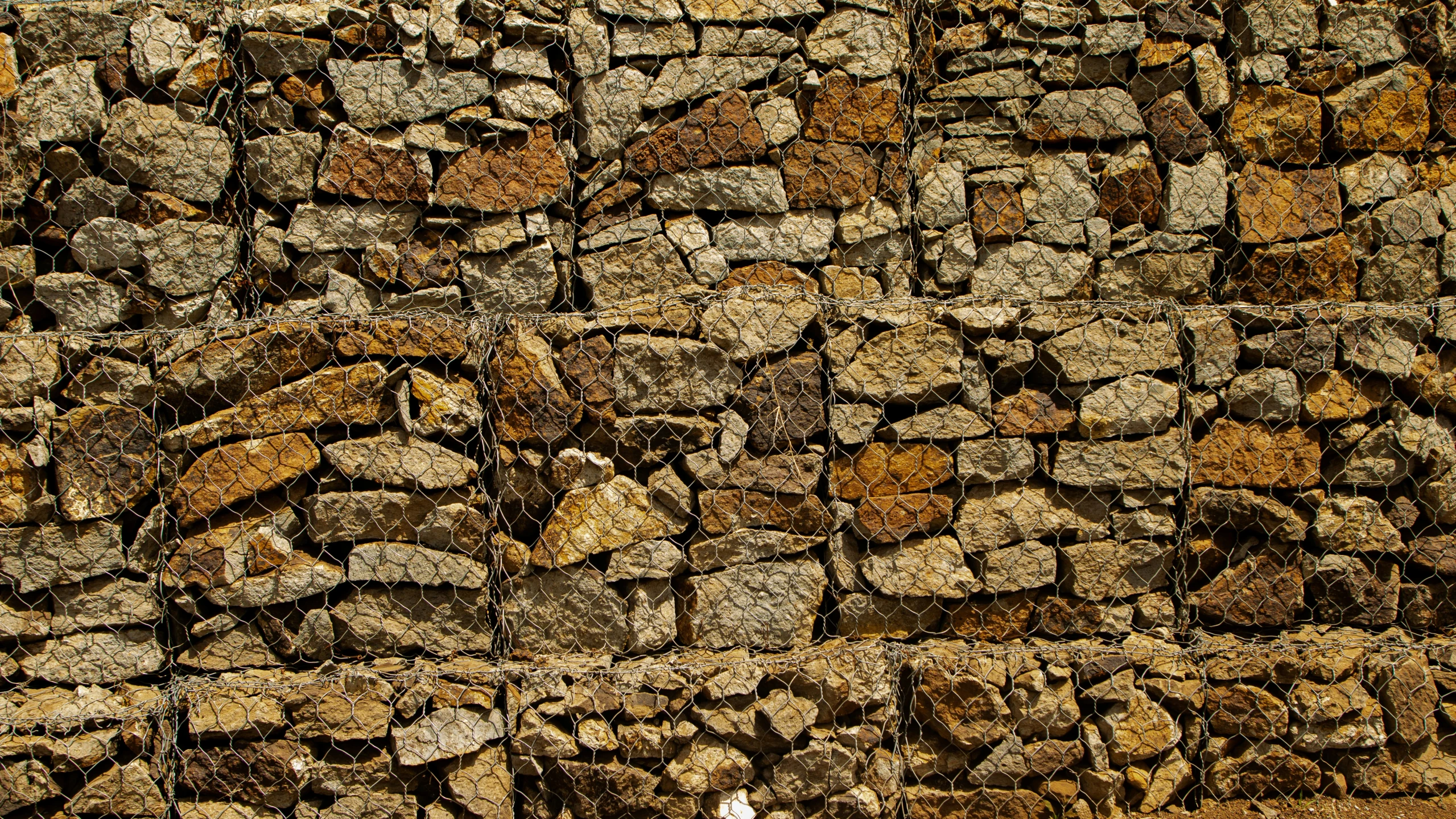 the sidewalk is lined with rocks and is brown